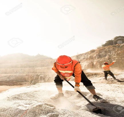 Heat Stress miner shuveling sand under the sun