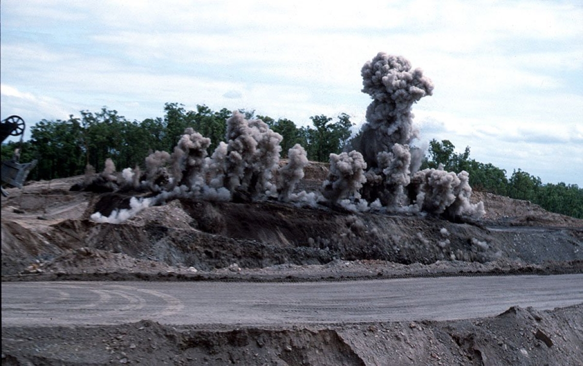 Clouds of dust rise as blasting occurs at mine