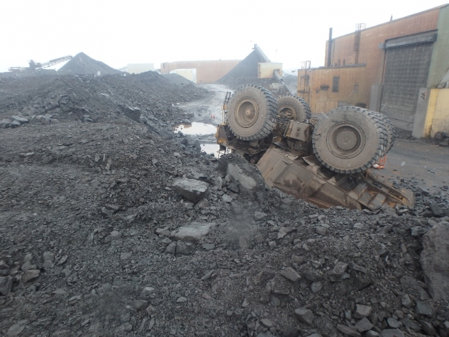 On April 29, 2019, a miner suffered minor injuries when his haul truck traveled over the edge of a stock pile dump point causing the truck to roll onto its top. The driver was wearing a seat belt.