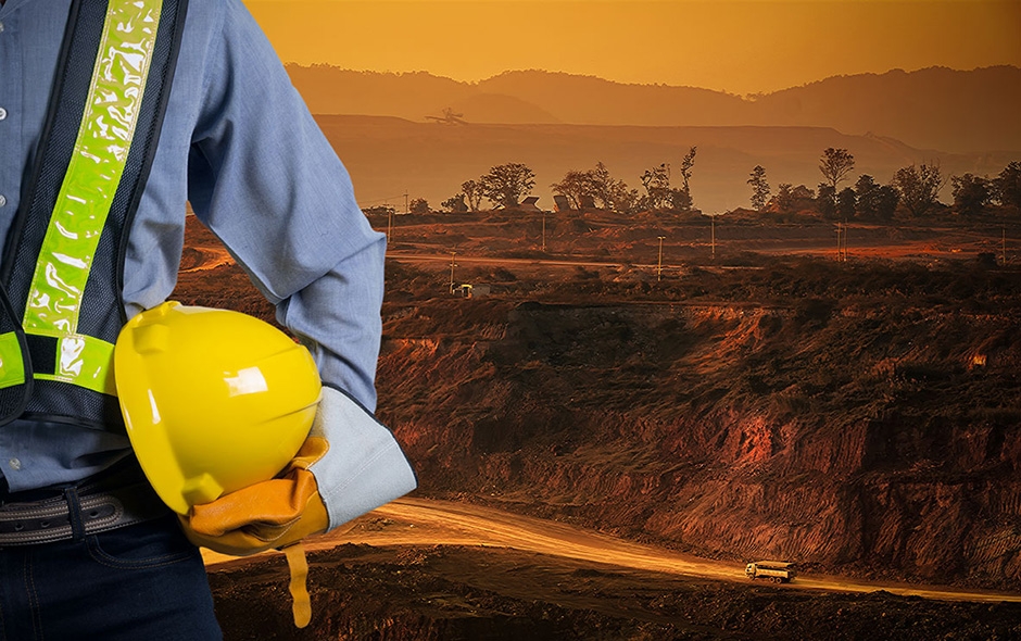  A mine inspector holding his hard hat 