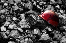 A worker's safety helmet sitting on top of mined material.
