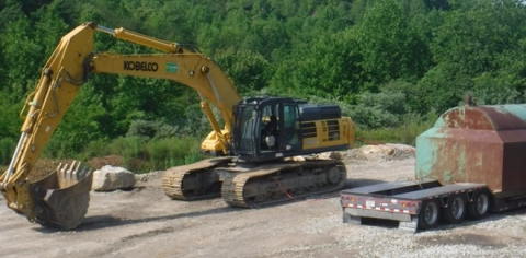 Accident scene where  a contract truck driver died when an excavator bucket struck him.