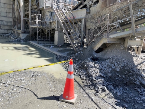 Accident scene where a front-end loader operator drowned, lying face down in a pool of water.