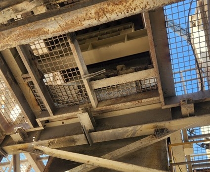 Accident scene where a contractor was installing a material feeder when they fell approximately 21 feet through an opening in the walkway platform.