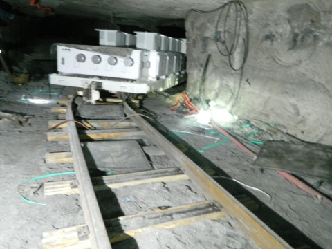 Accident scene where a miner was seriously injured when an air lifting bag he was using to rerail the conveyance that was carrying the longwall electrical power center suddenly dislodged.