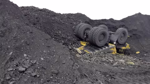 Accident scene where a miner died when his haul truck traveled over the edge of a stockpile and overturned.