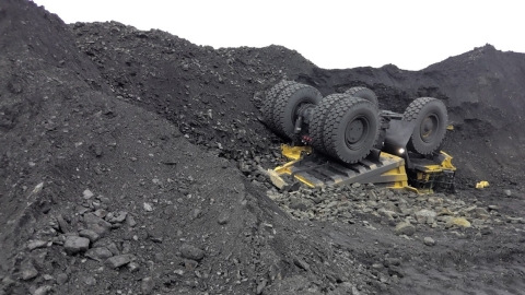 Accident scene where a miner died when his haul truck traveled over the edge of a stockpile and overturned.