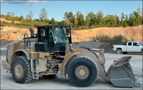 Accident scene where a miner died after he fell approximately six feet from a front-end loader while attempting to replace a bulb on the right front headlight. 