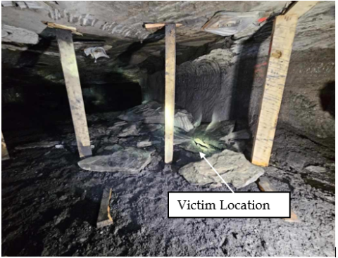 Accident fatality scene where a shuttle car operator was struck by falling rock from the mine roof while setting timber posts during retreat mining. 