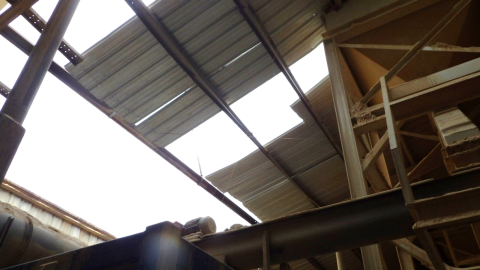 Accident scene where a contractor died after falling approximately 37 feet through an unsecured roof panel of a shaker screen deck while conducting roof repairs.