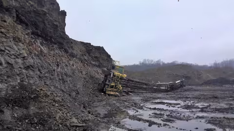 Accident scene where a miner died when the ground beneath the drilling rig he was operating failed, causing it to overturn and fall off the highwall.
