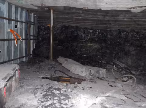 Accident scene where a miner died when a piece of rock fell from an unsupported pillar rib and struck him.