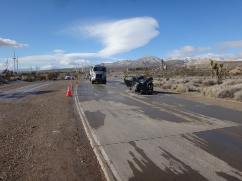 Accident scene where a miner was fatally injured when his personal car collided with a customer truck. Both vehicles were traveling toward each other in opposite directions on an icy mine access road.