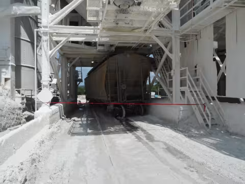 Accident scene where a miner died when a covered hopper railcar derailed and pinned him against a structural beam of a train load out silo.