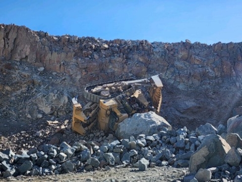 Accident scene where a contract bulldozer operator died when the bulldozer he was operating backed off the edge of a highwall. 