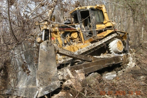 Accident scene where a miner died when the bulldozer he was operating went over an embankment, ejecting him from the operator’s cab.