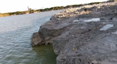 Accident scene where a miner drowned when the ground sloughed causing the excavator he was operating to topple into a water-filled pit.  The excavator became submerged in approximately 25 feet of water.