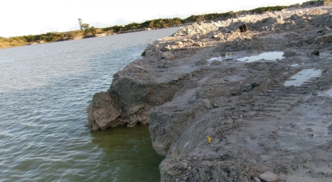 Accident scene where a miner drowned when the ground sloughed causing the excavator he was operating to topple into a water-filled pit. The excavator became submerged in approximately 25 feet of water.