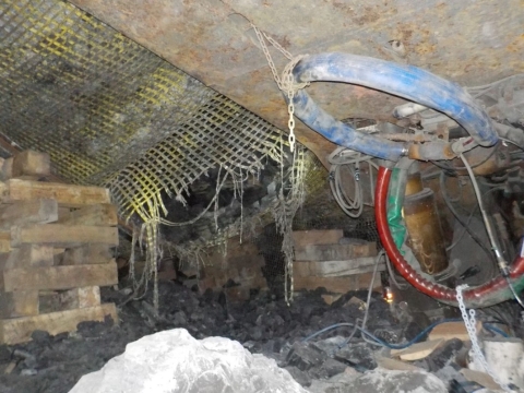 Accident scene where  a miner died when the mine roof collapsed during the installation of standing roof support (crib) as part of the longwall recovery cycle.  The accident occurred in an area adjacent to a longwall shield.