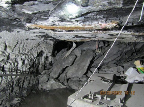 Accident scene where a 33 year-old miner died when he was struck by a roof fall while moving a waterline outby the retreat mining section. 