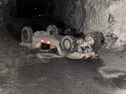 Accident scene where a miner died when the personnel carrier he was riding overturned.  Another miner riding on the personnel carrier accidentally actuated the emergency stop causing the personnel carrier to drift backwards down a grade.