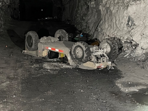 Accident scene where a miner died when the personnel carrier he was riding overturned.  Another miner riding on the personnel carrier accidentally actuated the emergency stop causing the personnel carrier to drift backwards down a grade.