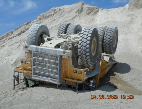 Accident scene where a miner died when the haul truck he was operating overturned, when the edge of the bank at a dump point gave way.