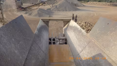 Accident scene where a miner died when he fell from the discharge area of a feed hopper while attempting to dislodge a rock.