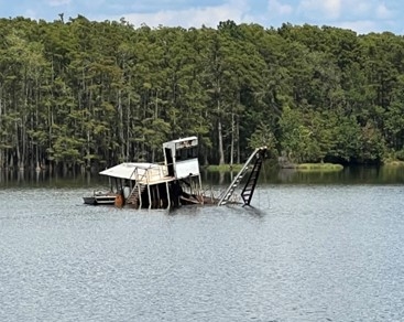 Accident scene where a dredge operator drowned while working in a dredge pond.