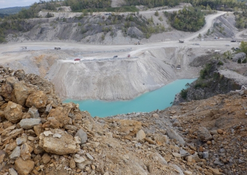 Accident scene where a haul truck operator died after his haul truck backed through the berm at a dump point and became submerged in a pond.