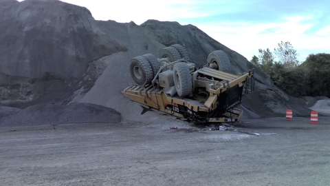 Accident scene where a contract haul truck driver was injured while dumping a load of material at the top of a stockpile.