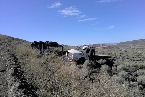 Accident scene where a contractor driller helper died while driving a service truck to transport a rod handler on the bed.