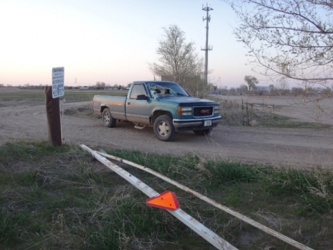 Accident scene where a gate pole entered the truck’s windshield as the pickup truck approached, striking the victim and causing fatal injuries.