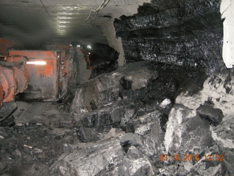 Accident scne where a 34-year-old section foreman with 10 years of mining experience was killed when a coal/rock rib approximately 90 inches long, 45 inches high, and 15 to 18 inches thick fell and pinned him against the side of a shuttle car.
