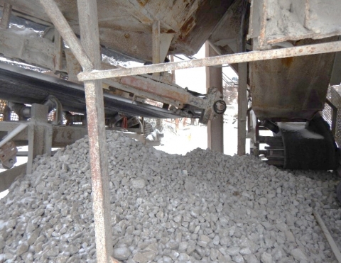 Accident scene where a miner was fatally injured when he became entangled in a fluted tail pulley while attempting to shovel under an adjacent fluted tail pulley.