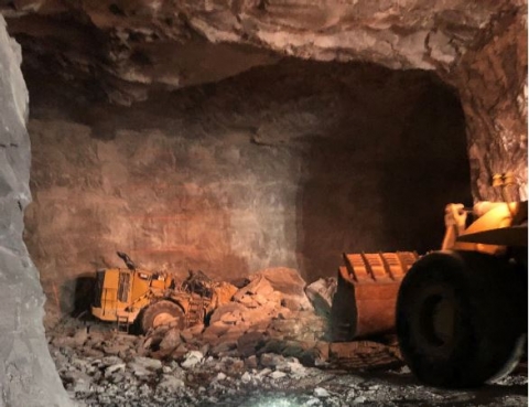 Accident scene where a 49 year-old front-end loader operator with 15 years of mining experience died when a large rock fell from the mine roof, crushing the cab of the front-end loader.