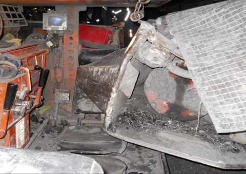 Accident scene where the miner was in the operator’s compartment of his shuttle car, traveling through the last open crosscut, when a second shuttle car traveled through a ventilation curtain and struck his shuttle car.