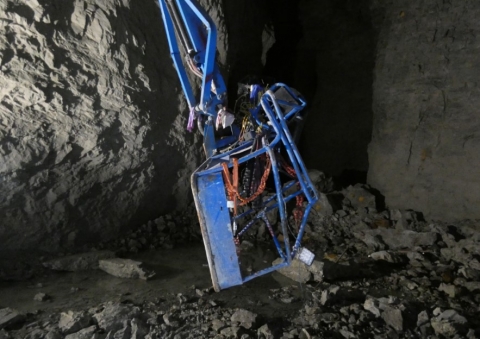 accident scene where a rock falling from a pillar in a benched area at a room-and-pillar zinc mine struck a miner