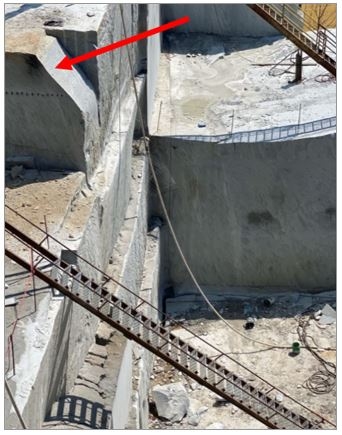 Accident scene where a miner was standing on a rock ledge to extract dimensional stone when a triangular section of the rock broke off, causing the miner to fall approximately 35 feet.