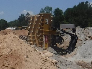 Accident scene where a contract miner died when the compactor he was operating overturned, pinning him beneath the cab. 