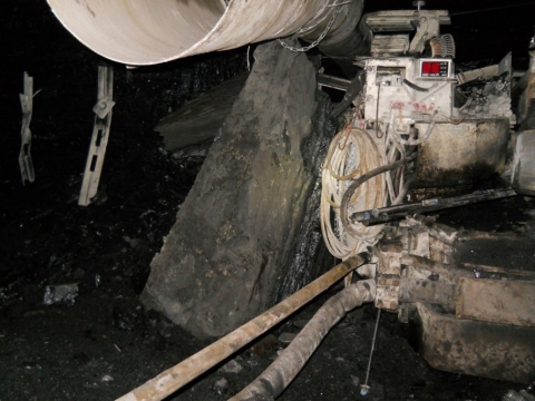 accident scene where the foreman with five years of mining experience was pinned against a continuous mining machine by a piece of rib. The piece fell while he was installing a rib bolt with the machine mounted rib drill