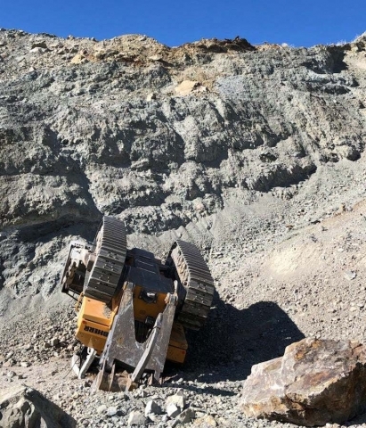 Accident scene where a 37 year-old bulldozer operator died when the bulldozer he was operating went over the edge of the highwall, landing upside down on the pit floor.