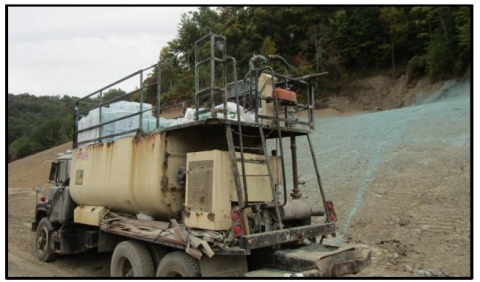 accident scene where the material sprayed from the nozzle struck him, causing him to fall backward and strike his neck on the hydroseeder handrail.