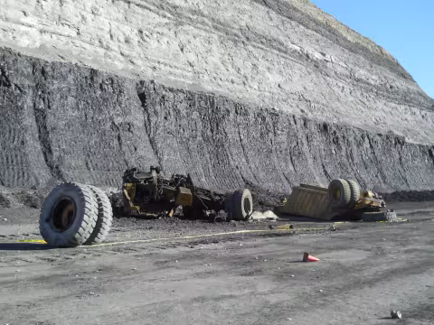 Photo of rock truck shattered on ground from where it fell, 240 feet above