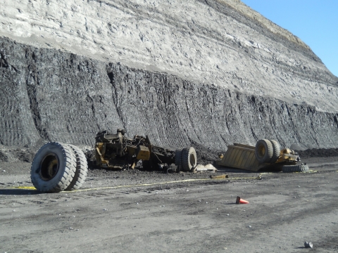 Photo of rock truck shattered on ground from where it fell, 240 feet above