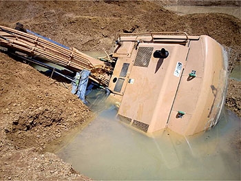 excavator fell on its side