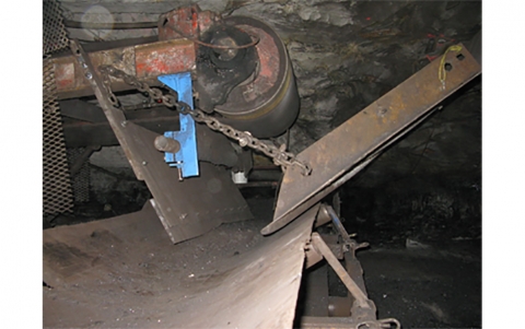 Accident scene a 19 year old underground miner with fifteen weeks of mining experience was killed when he became caught between the "V" shaped coal discharge guides adjacent to the discharge roller of the section conveyor belt.