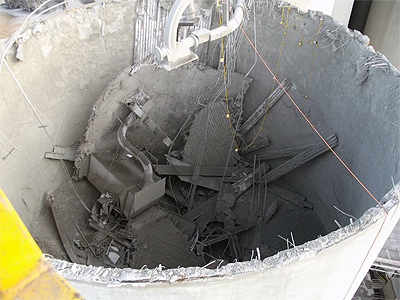 top view of a silo with its roof caved inward.