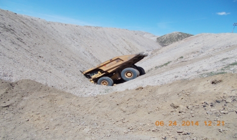 Photo of accident scene; the haul truck is crashed into the spoil "V"