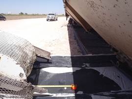 Close up angle of where the feed spout meets the conveyor